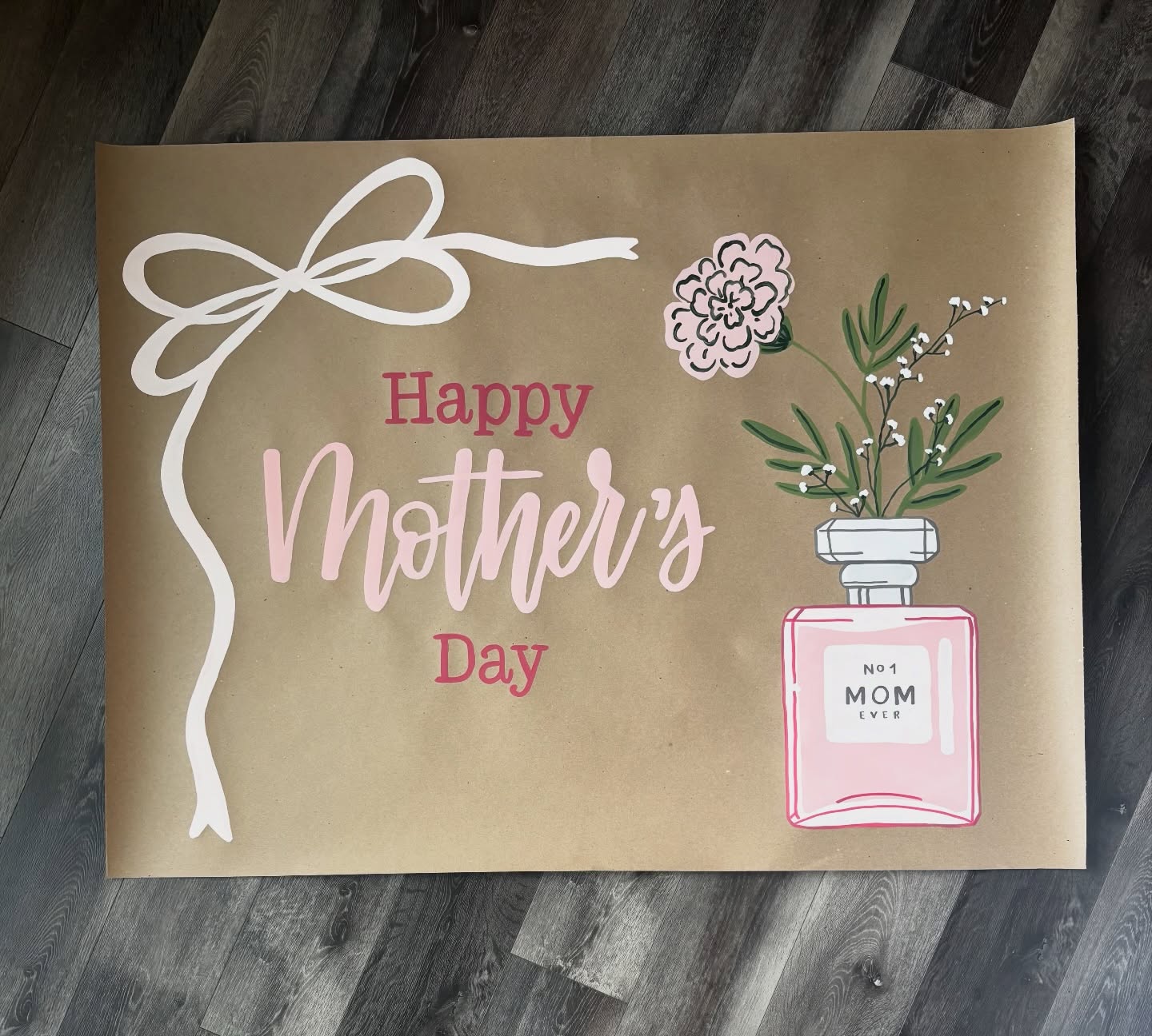 Hand-painted 'Happy Mother's Day' banner on kraft paper with a painted perfume bottle and flowers